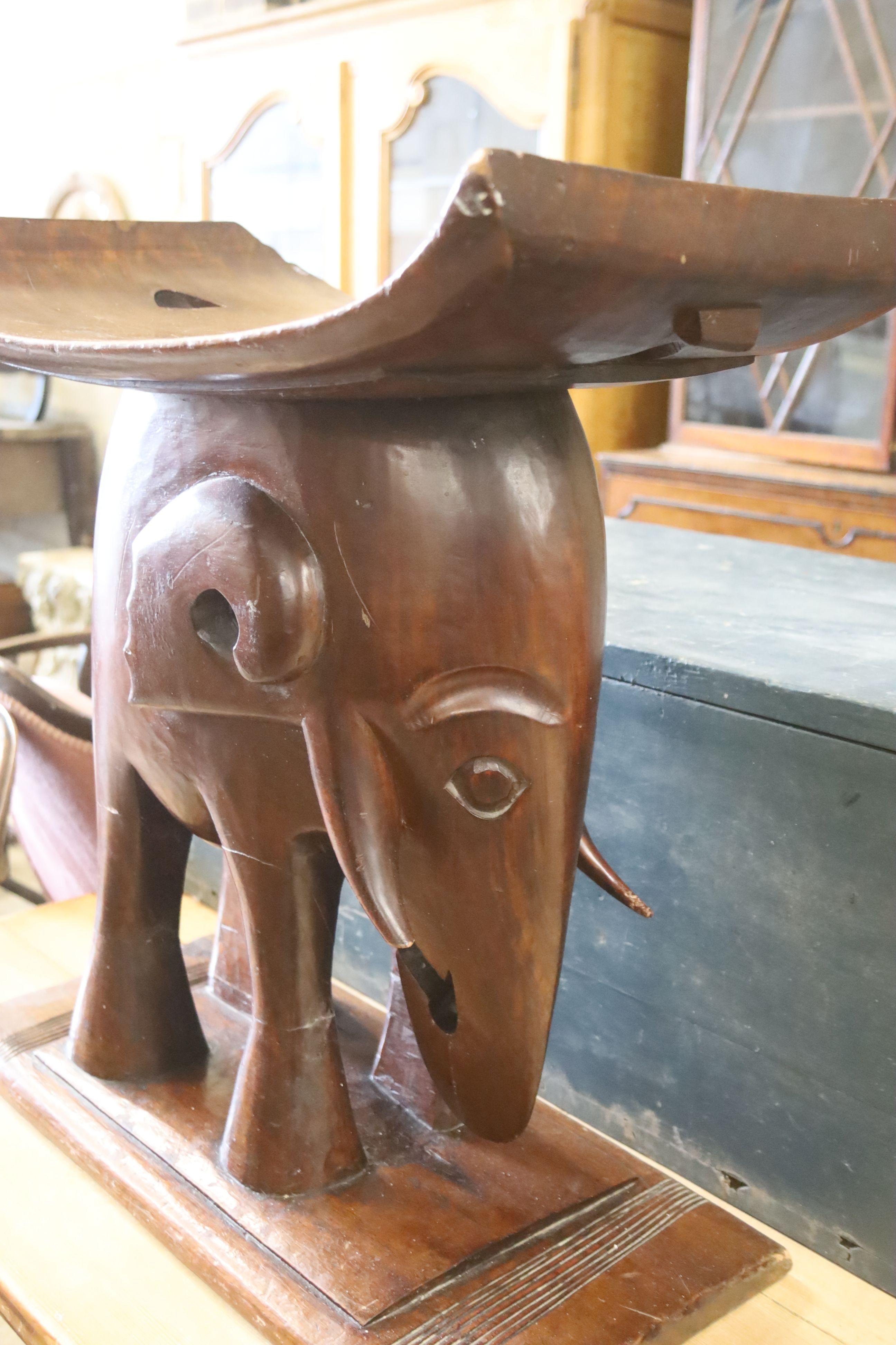 An Ashanti carved elephant stool, width 55cm, depth 26cm, height 58cm
